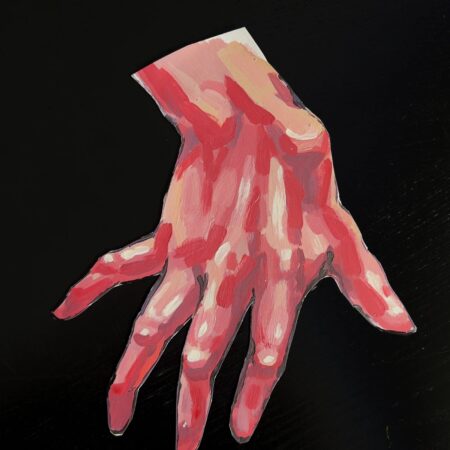 Painted hand cutout against a black background