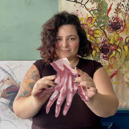 Person holding the hand cutout for scale